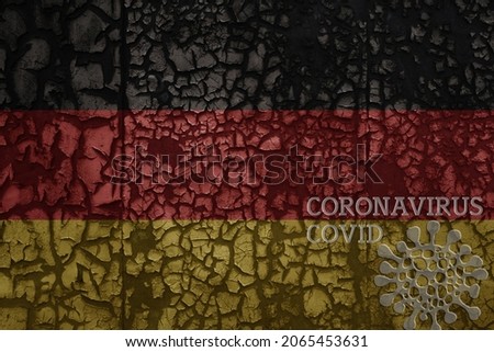 flag of germany on a old vintage metal rusty cracked wall with text coronavirus, covid, and virus picture.