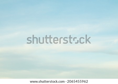 Blue sky background with cirrus clouds.