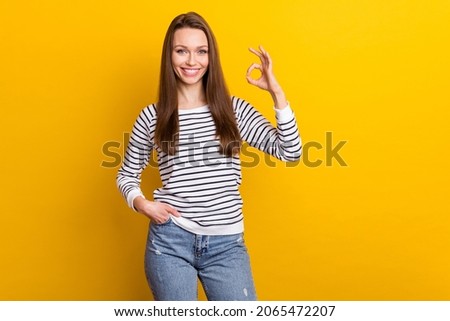 Photo of cool brunette young lady show okey wear white jumper isolated on yellow color background