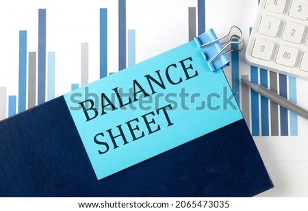 BALANCE SHEET on sticky note on the notebook on the chart background