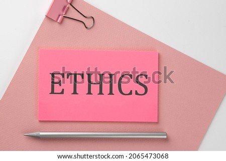 Pink sticker on pink paper with pencil on white background with text ETHICS