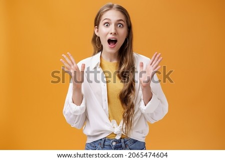 Portrait of amused and excited talkative lively cute woman in glamourous outfit gesturing with rased hands open mouth from surprise and amazement retelling awesome news to friend, gossiping thrilled Royalty-Free Stock Photo #2065474604