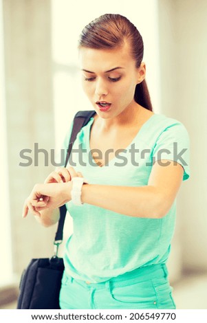 picture of surprised student girl looking at clock
