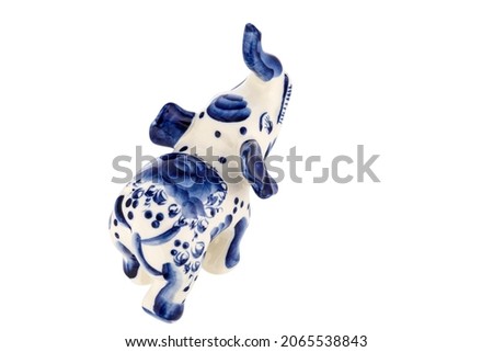Cute Elephant Figurine Sculpture Porcelain Ceramic Isolated on white background. Cobalt Blue color is traditional folk painting. Decor for interior of premises.