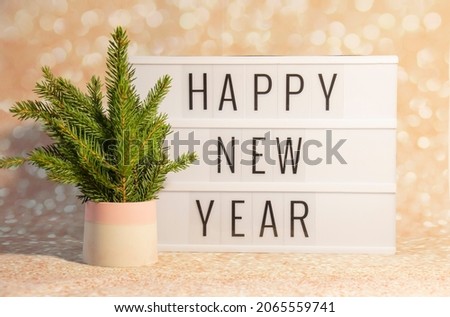 Happy New Year displayed on vintage lightbox with eco tree New Years Eve, concept image 