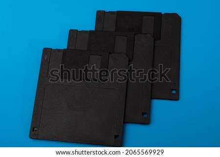 Stack of floppy disks over blue background