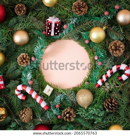 Christmas creative background with circle copy space made of New year decoration, pinecones and fresh evergreen tree. Flat lay.