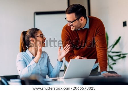 Young female employee consulting with manager Royalty-Free Stock Photo #2065573823
