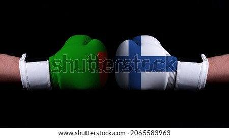 Two hands of wearing boxing gloves with Finland and Zambia flag. Boxing competition concept. Confrontation between two countries