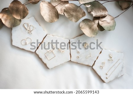 Small selection of minimalistic jewelry on a plain and white background