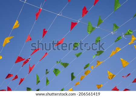 Bunting, colorful party flags, on a blue sky.