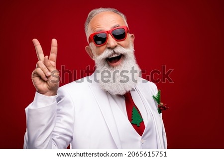 Photo of cheerful old cool man make v-sign good mood wear tree tie xmas isolated on red color background