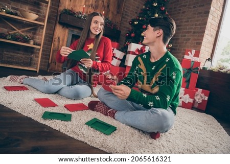 Full body photo of young couple happy positive smile write card congratulation merry christmas advent indoors