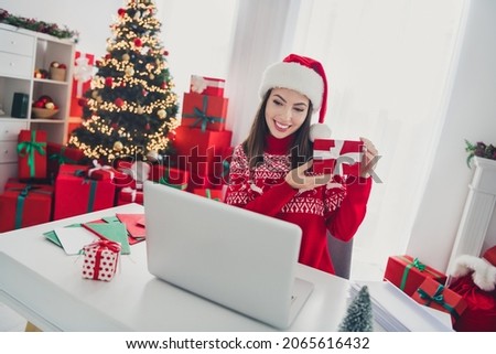 Photo of young lovely girl demonstrate gift box conversation vide call laptop xmas decor holiday indoors Royalty-Free Stock Photo #2065616432
