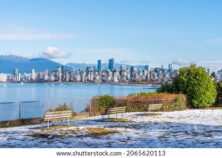 Beautiful snow in winter park with bench. Vancouver. Canada.