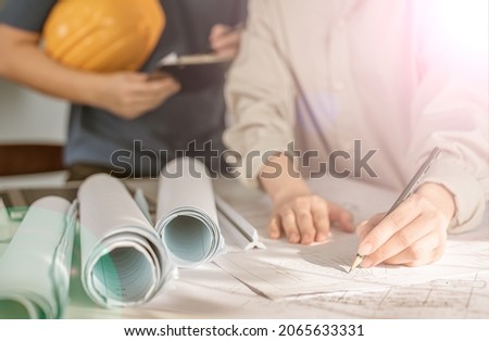 Architect working on blueprint. Architects workplace - architectural project, blueprints, ruler, calculator, laptop and divider compass. Construction concept. Blue print is fake only for stock photo. Royalty-Free Stock Photo #2065633331