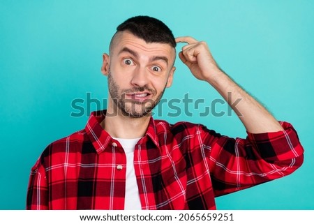 Photo of unhappy upset puzzled man hold finger head forget worried negative isolated on teal color background