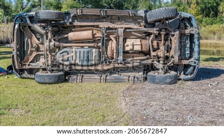 Pickup Truck rolled on side after leaving roadway and in and out of ditch. Royalty-Free Stock Photo #2065672847