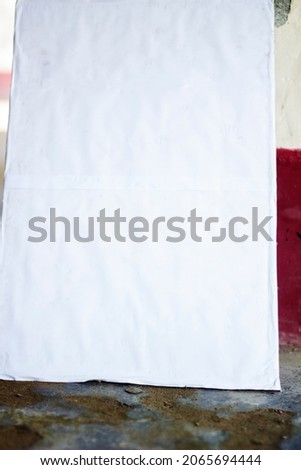 a white blank signboard Leaning against the wall for photo frame
