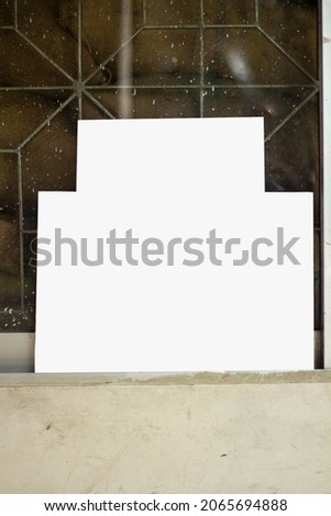 a white blank signboard Leaning against the wall for photo frame