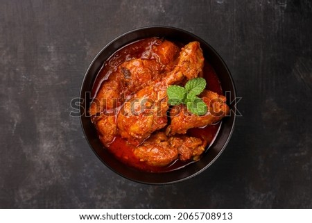 Spicy red chicken curry. Goan style chicken vindaloo. Butter chicken Murgh Makhani curry roast hot and spicy gravy dish Dhaba Punjab, India. North Indian non-vegetarian cuisine Garam Masala. tikka Royalty-Free Stock Photo #2065708913