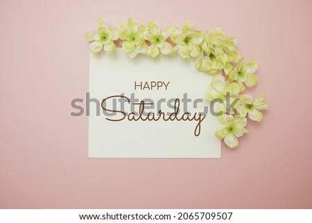 Happy Saturday card typography text with flower bouquet on pink background