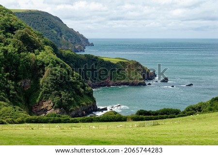 Lee Bay and Crock Point with Woody Bay and Wringapeak beyond, viewed from Lee Abbey near Lynmouth, Exmoor, Devon, UK Royalty-Free Stock Photo #2065744283