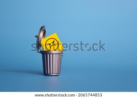 Remove negative thoughts, anger management concept. Wooden cube with angry face icon inside dustbin, trash can. Royalty-Free Stock Photo #2065744853
