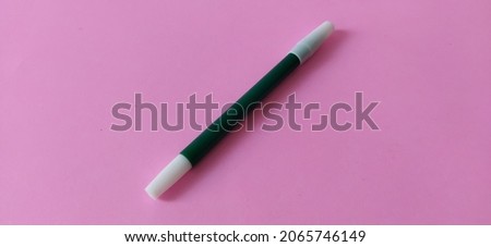 Green marker on blue manila paper