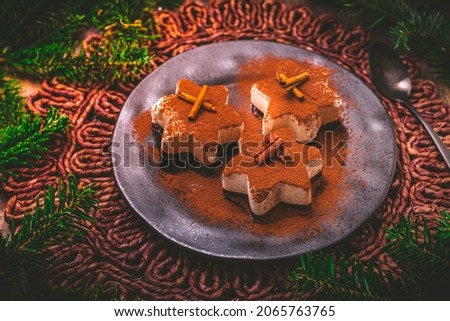 Christmas cinnamon ice dessert in star shape with ornaments 