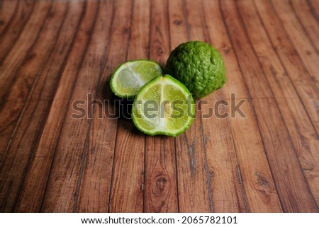 Kaffir lime or Bergamot on wooden textured background. Free copy space