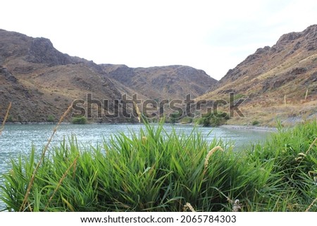 Small lake, leaves and mountains.  Very beautiful picture.