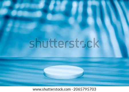 Abstract minimal nature scene - empty stage and circle podium on blue background with soft water waves shadows. Pedestal for cosmetic or beauty product and packaging mockups display presentation