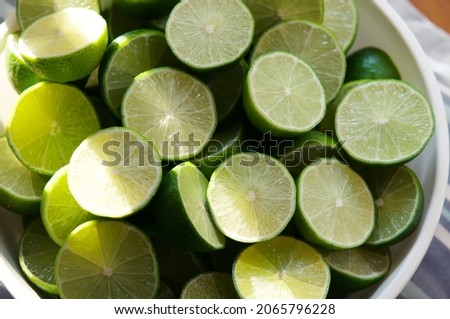 Lime Background with sun light from outside. Close up shot of limes. Selective Focus of sliced lime. Lime is a kind of fruit. The result is very sour for cook the Thai food style Royalty-Free Stock Photo #2065796228