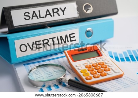 Salary, Overtime. Binder data finance report business with graph analysis in office. Royalty-Free Stock Photo #2065808687