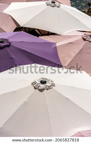 Close-up of a group of colorful beach umbrellas, view from above, photography full frame. Beach holiday or UV protection concept.