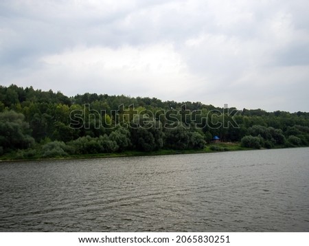 river bank on a cloudy day, in summer