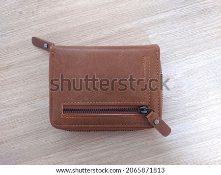 Photo of a small wallet for men made of brown leather