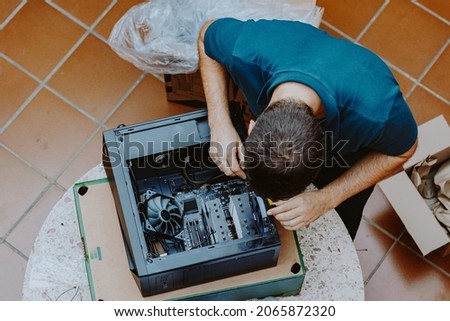 Technician repair assembles computer at home. Computer repair, assembling a personal computer. Working from home. Technology background. Pc build. Installing Hardware components. Royalty-Free Stock Photo #2065872320