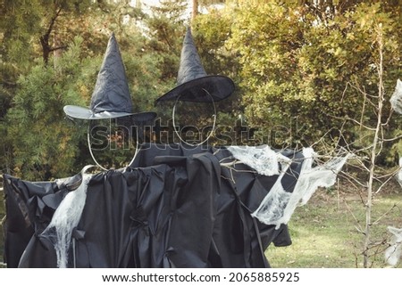 Halloween witch scarecrow and spider web decoration. Yard decor and holiday photo zone ideas for party. Selective focus, copy space