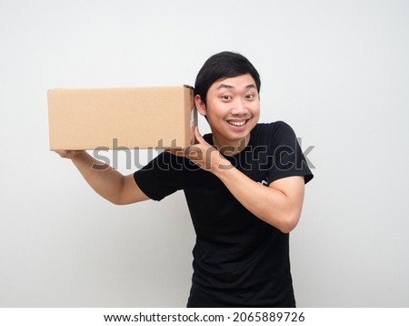 Man holding box and listening it feeling excited with the box