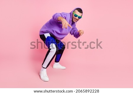 Full length photo of funky young brunet guy dance wear eyewear hoodie pants shoes isolated on pink background Royalty-Free Stock Photo #2065892228