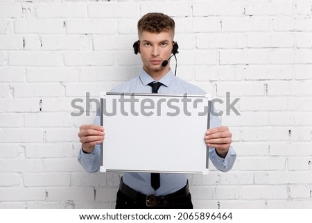 Young businessman is showing the word. Your text here