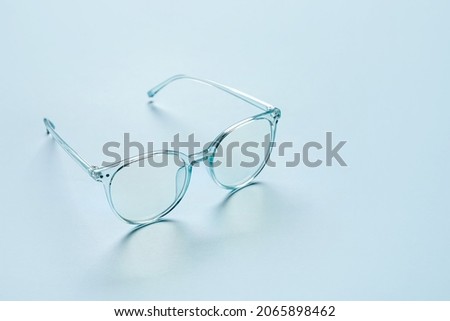 Stylish eyeglasses on color background Royalty-Free Stock Photo #2065898462