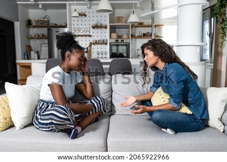 Two sad depressed and anxious diverse women talking at home. Female friends supporting each other. Problems, friendship and relationships difficulties care concept Royalty-Free Stock Photo #2065922966