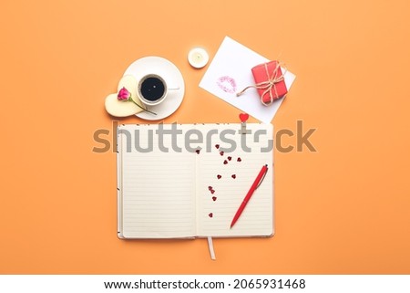 Notebook with cup of coffee and gift for Valentines Day celebration on color background