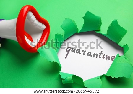 Toy megaphone and word QUARANTINE visible through torn color paper