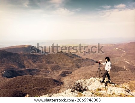 Side view brunette caucasian woman travel photographer shooting landscape photo outdoors