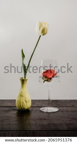 still life tulip vase and glass, toy, coin bitcoin