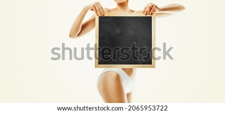 woman with a healthy body holding white blank board - health concept